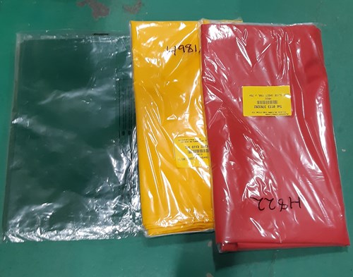 three plastic sheets in red, yellow and blue
